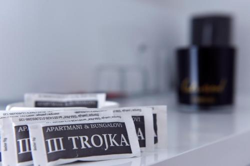 a pile of newspapers sitting on top of a table at Apartmani i Bungalovi TROJKA in Banja Luka