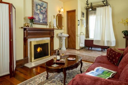 a living room with a couch and a fireplace at Engadine Inn and Cabins in Candler