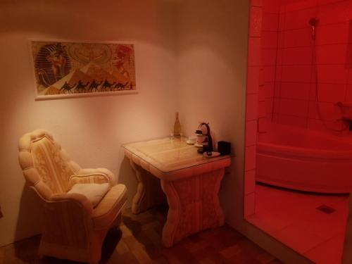a bathroom with a small table and a shower at FARAON pn 3 in Paraćin