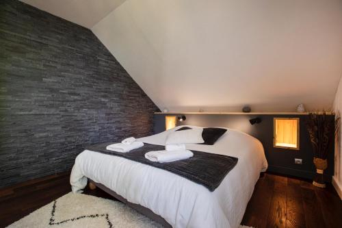 a bedroom with a large bed with towels on it at Appartement Vue Lac in Malbuisson