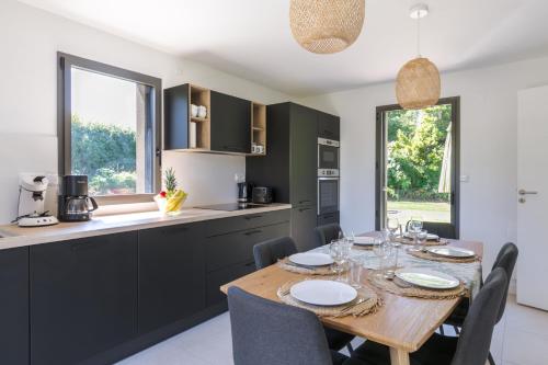 une cuisine et une salle à manger avec une table et des chaises en bois dans l'établissement Kermaudez, à Pleubian