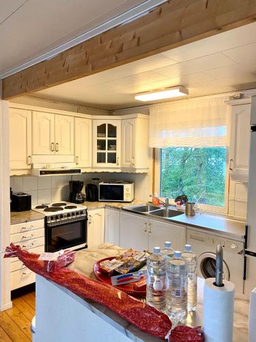 a kitchen with white cabinets and a counter top at Escape to Your Very Own Private Island - Just 30 Minutes from Stockholm in Svartsjö