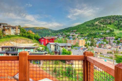 a view of a city from a balcony of a town at The Perch Park City - Magnificent 6 BR House With Views, Elevator, Game Room, Hot Tub in Park City