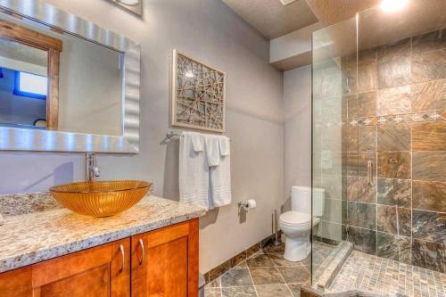 a bathroom with a sink and a glass shower at The Perch Park City - Magnificent 6 BR House With Views, Elevator, Game Room, Hot Tub in Park City