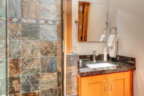 a bathroom with a sink and a shower at The Perch Park City - Magnificent 6 BR House With Views, Elevator, Game Room, Hot Tub in Park City