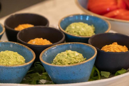 a group of small blue bowls on a plate at Hotel Starkl - Heritage & Unique in Bled