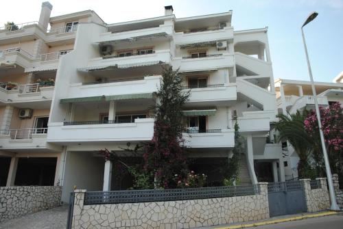 a white building with a fence in front of it at Villa Dulsinea in Ulcinj