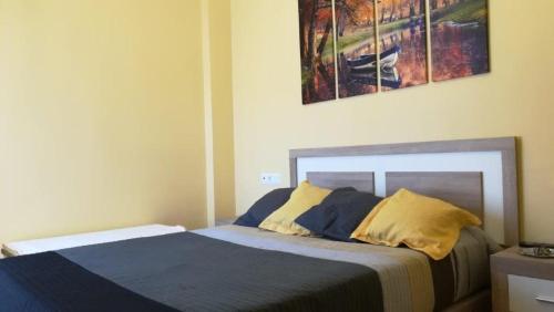 a bedroom with a bed and a painting on the wall at Torrox Costa in Málaga