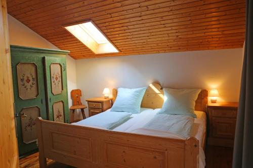 a bedroom with a large bed with two pillows at Ferienwohnungen Mittermayer in Aschau im Chiemgau
