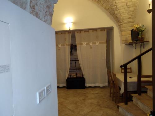 a room with a staircase and curtains in a building at Soggiornare In Centro in Alberobello
