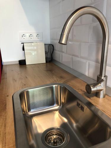 a stainless steel sink in a kitchen next to a counter at El Escondite de la Muralla in Cáceres
