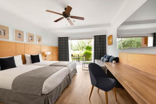 a bedroom with a bed and a ceiling fan at Hotel Riu Tikida Garden - Adults Only - All Inclusive in Marrakech
