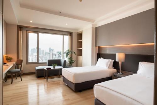 Katil atau katil-katil dalam bilik di Jasmine City Hotel