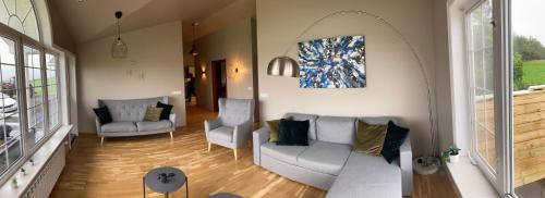 a living room with a couch and two chairs at Iceland Inn Lodge, entire place with hot tub. in Selfoss