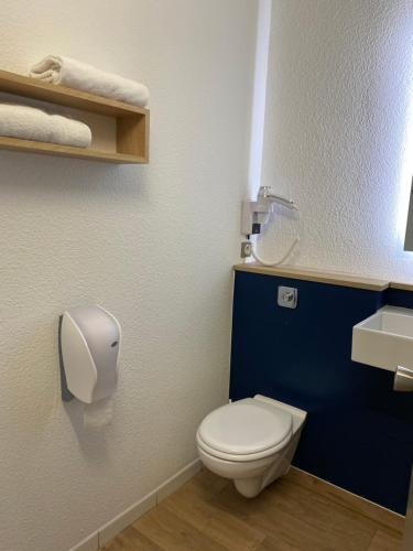 a bathroom with a white toilet and a sink at Kyriad Direct - Bourg les Valence in Bourg-lès-Valence