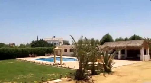 a house with a swimming pool in a yard at شاليه بالساحل الشمالى* in Kafret Eilet el Taflal