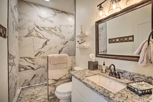 a bathroom with a sink and a toilet and a mirror at Rancho Santa Fe Casita - Gate Guarded Community! in Rancho Santa Fe