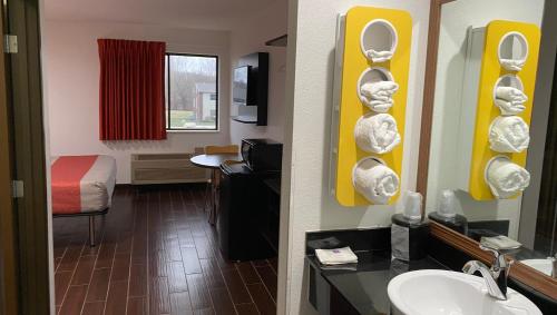 a hotel room with a bathroom with a sink and a mirror at Relax Inn in Franklin