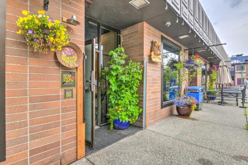 a building with potted plants on the side of it at Modern Downtown Apt - Walk to Parks and Cafes! in Anchorage