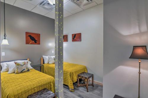 a bedroom with two beds and a lamp at Modern Downtown Apt - Walk to Parks and Cafes! in Anchorage