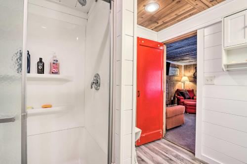 een rode deur in een kamer met een woonkamer bij Lakefront Rocky Mount Main House with 3 Cabins! in Rocky Mount