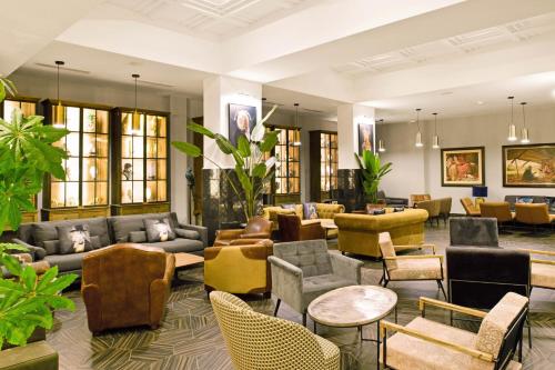 a lobby with couches and chairs and tables at Hotel Riu Tikida Garden - Adults Only - All Inclusive in Marrakech