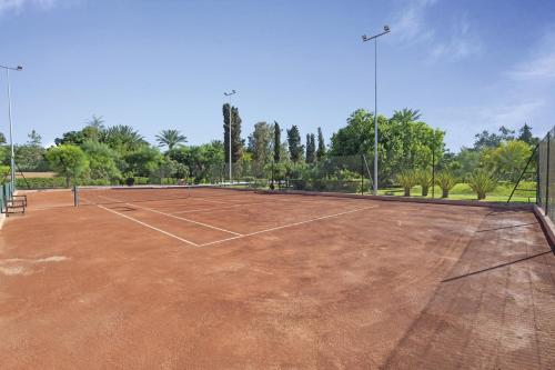 a tennis court with a tennis racket on it at Hotel Riu Tikida Garden - All Inclusive Adults Only in Marrakesh
