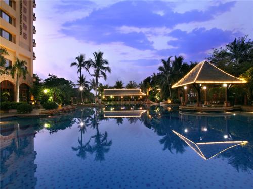 a pool at a resort at night at Timton Fuhe Hotel, Sanya in Sanya