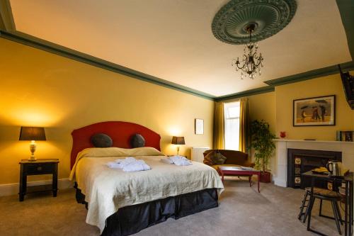 a bedroom with a bed and a chandelier at Tudhoe Park House in Durham