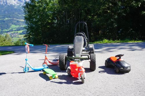 a group of childrens toys parked in a parking lot at Appartement Winteraugut in Werfen