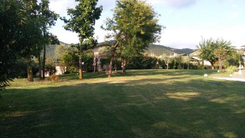 a large green yard with trees and a house at Appartamento seminterrato Villa Sveva Franciacorta in Ome