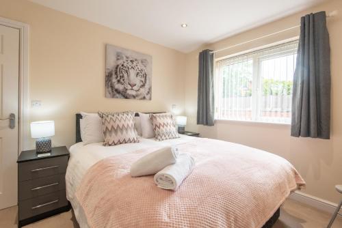 a bedroom with a bed with two pillows and a window at Apartment 10 in Worksop