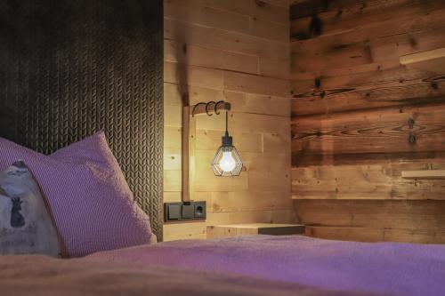 a bedroom with a purple bed and a lamp at Apartment Steger 2 in Mittersill