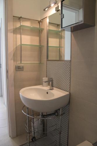 a bathroom with a sink and a mirror at FRONTE MARE VIA DELLE DUNE in Baia Verde