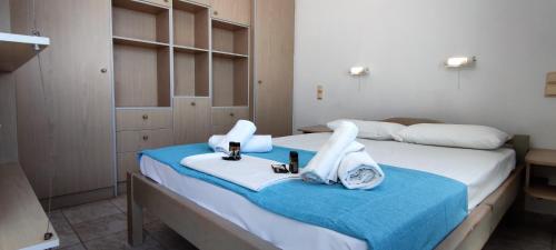 um quarto com uma cama com toalhas em Splash Apartments em Makry Gialos
