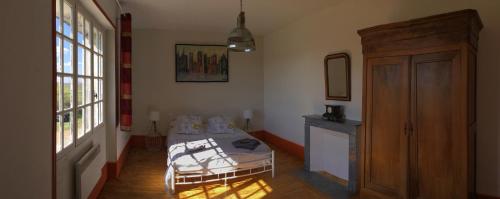 a room with a bed and a table and a window at COTTAGE SAINTE GENEVIEVE in Champigny-sur-Veude