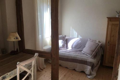 a bedroom with a bed and a window at La Maison du Rempart in Eguisheim