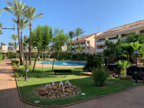 a park with a fountain in front of a building at Luxury Apartments Golden Beach Javea in Jávea