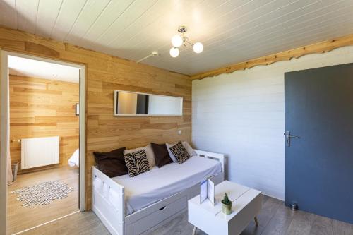 a bedroom with a bed in a room with wooden walls at La Sapinière St Lary Soulan in Saint-Lary-Soulan