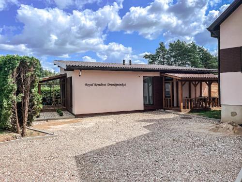 a house with a sign that reads get better architecture at Royal Resident in Druskininkai