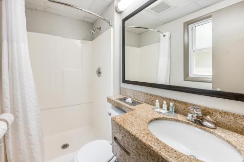 a bathroom with a sink and a shower at Rodeway Inn Poughkeepsie in Poughkeepsie