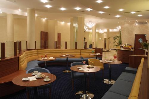 a restaurant with tables and chairs in a room at Nicotel Barletta in Barletta