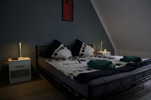 a bedroom with a bed with pillows and two lamps at Ferienwohnung an der A7 in Northeim