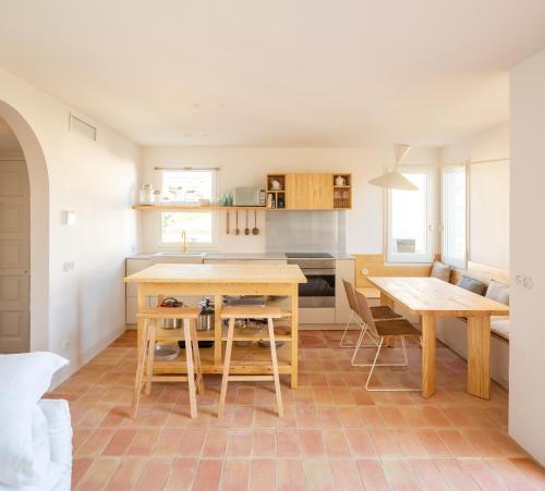 a kitchen with a table and two chairs and a table at Can Jove Cadaqués in Cadaqués