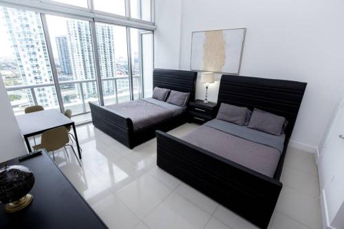 a bedroom with a bed and a couch and a table at ICON/W HOTEL LUXURY STUDIO@MIAMI DOWNTOWN/BRICKELL in Miami