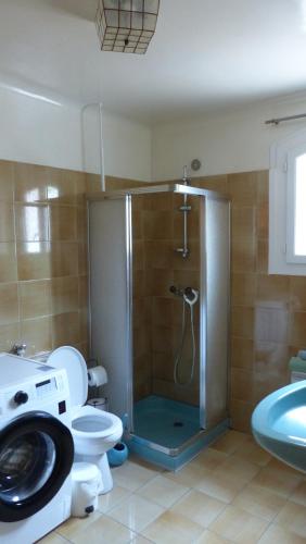 a bathroom with a shower with a toilet and a sink at Appartement Stade Aime Giral in Perpignan