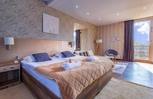 a hotel room with two beds with towels on them at Plaza La - Night and Spa in Sremska Mitrovica