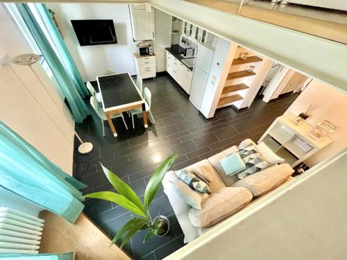 an overhead view of a living room with a couch at COZY LOFT MARINA VIEW in Savona