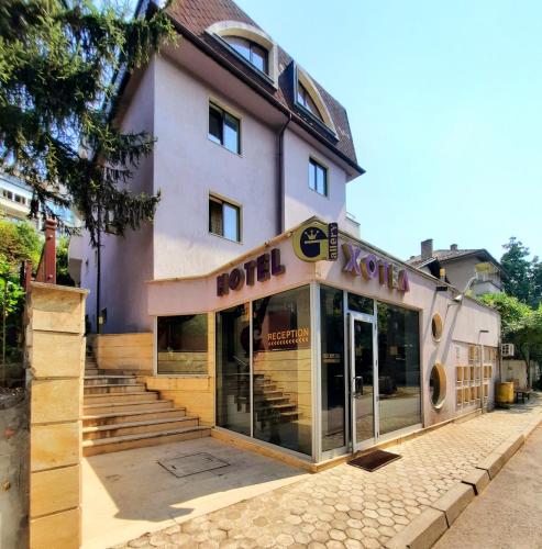a building with a hotel sign in front of it at Family Art Hotel Gallery in Pleven