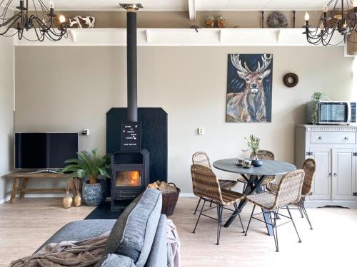 a living room with a table and a wood stove at 4seasonshouse in Losser